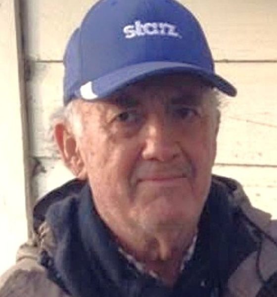 Elderly man wearing blue baseball cap outdoors