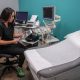 Healthcare professional reviewing ultrasound images in exam room