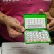 Person holding open birth control pill pack