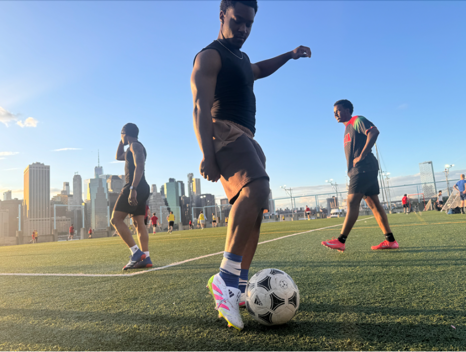Man controlling soccer ball on city field