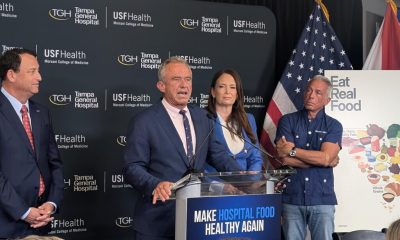 Man speaking at hospital nutrition press conference podium