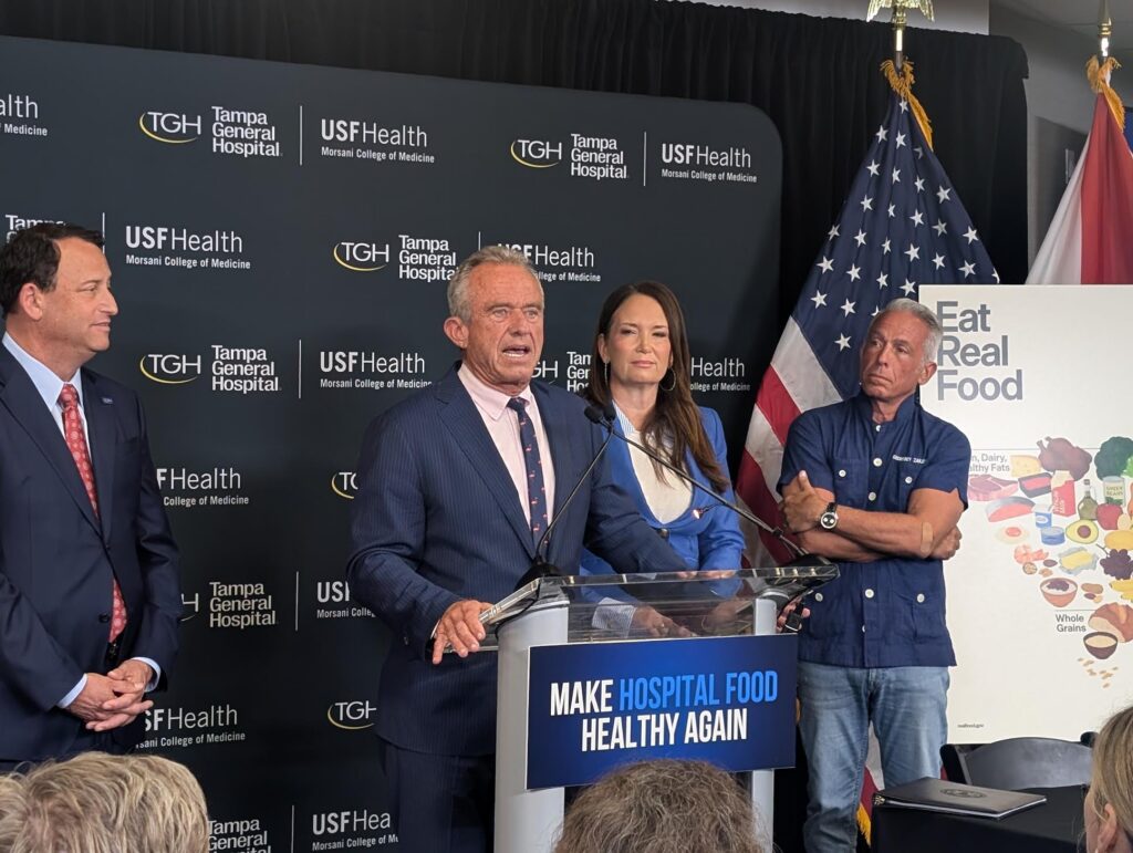 Man speaking at hospital nutrition press conference podium