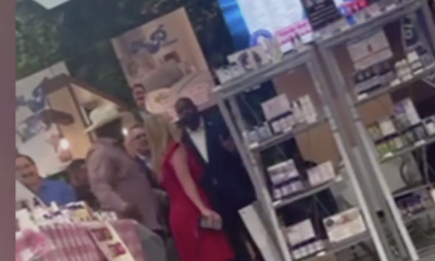 People posing inside a retail store with product shelves
