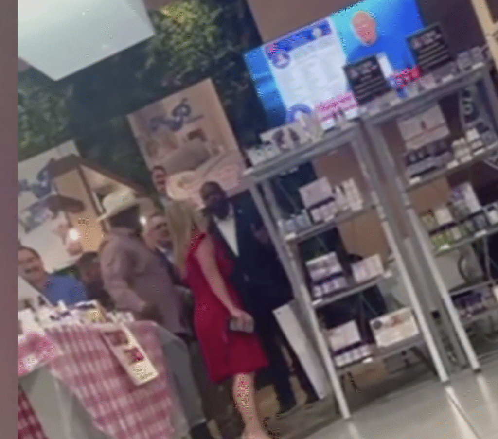 People posing inside a retail store with product shelves