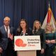 Officials at podium promoting American citrus protection