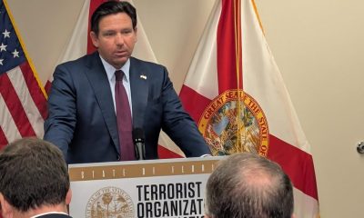 Man speaking at Florida press conference podium