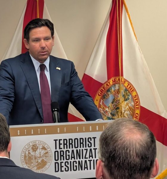 Man speaking at Florida press conference podium