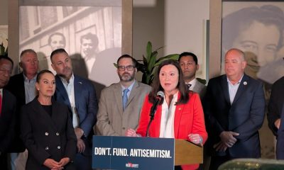 Woman speaking at podium about antisemitism