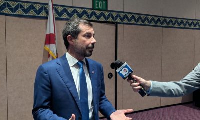 Man in blue suit interviewed by reporter