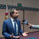 Man in blue suit interviewed by reporter