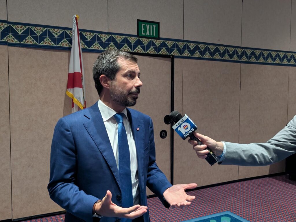 Man in blue suit interviewed by reporter