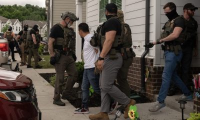 Officers detain man outside suburban home