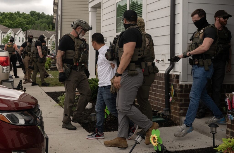 Officers detain man outside suburban home