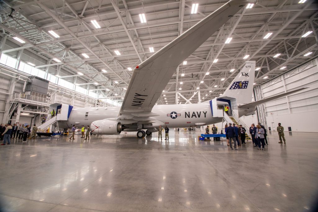 U.S. Navy aircraft inside large maintenance hangar