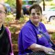 Two women sitting at outdoor picnic table
