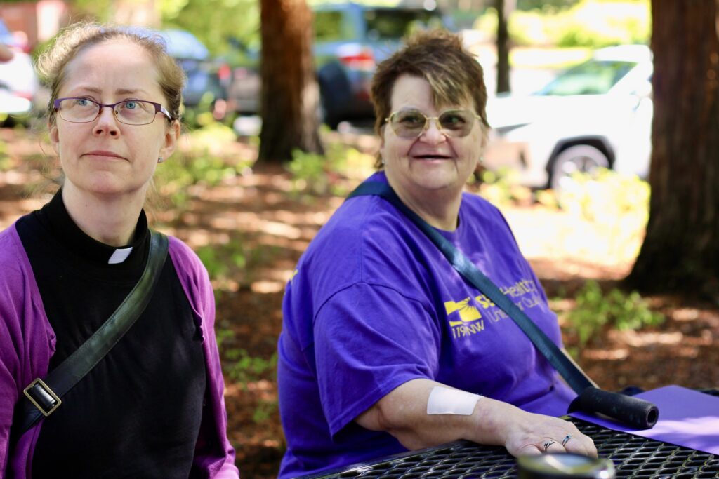 Two women sitting at outdoor picnic table