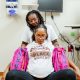 Pregnant woman supported in medical exam room
