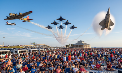 Airshow jets performing over large beach crowd