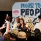 Woman speaking at political rally with crowd