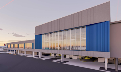 Modern airport terminal with jet bridges at sunset