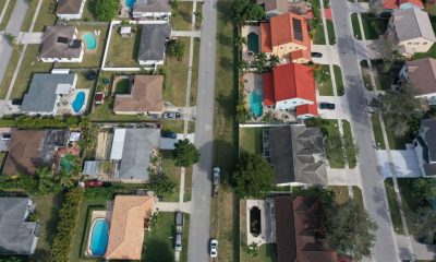 Aerial view of suburban homes with pools