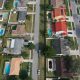 Aerial view of suburban homes with pools