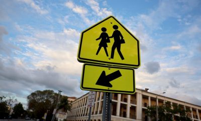 Yellow school crossing sign with left arrow