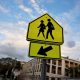 Yellow school crossing sign with left arrow