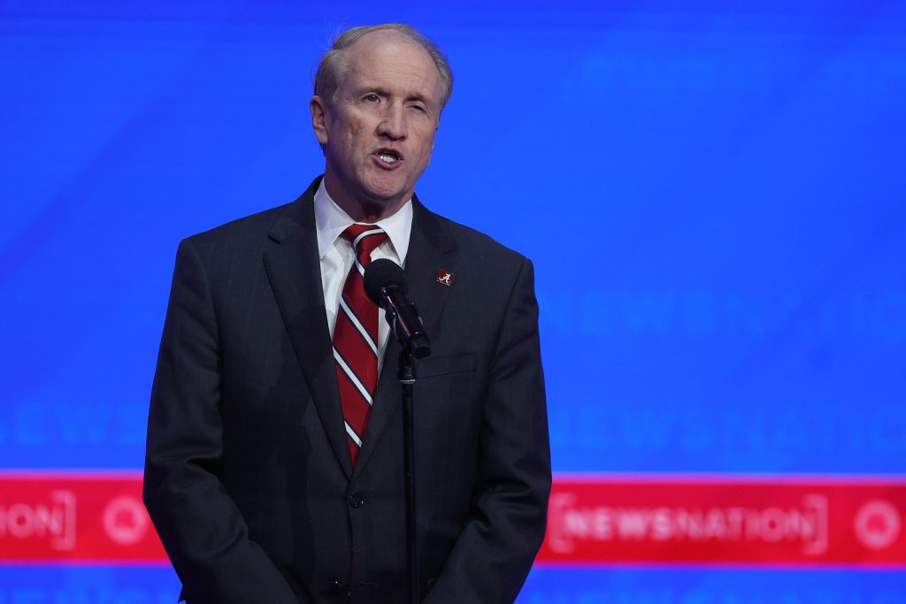 Man in suit speaking at podium