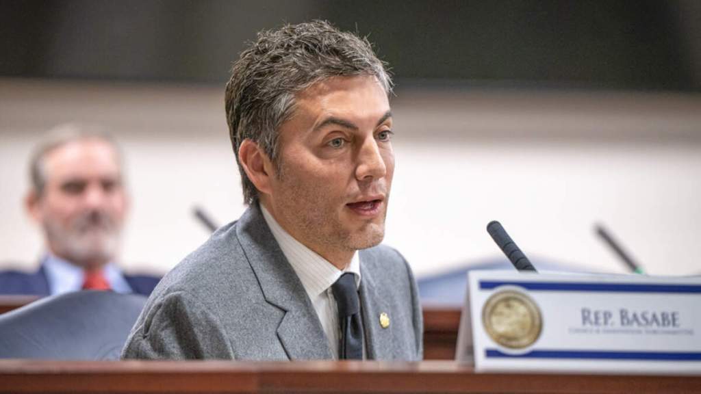 Man speaking at legislative hearing microphone