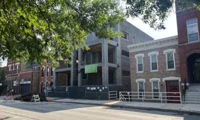 Brick building under construction on city street
