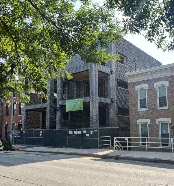 Brick building under construction on city street