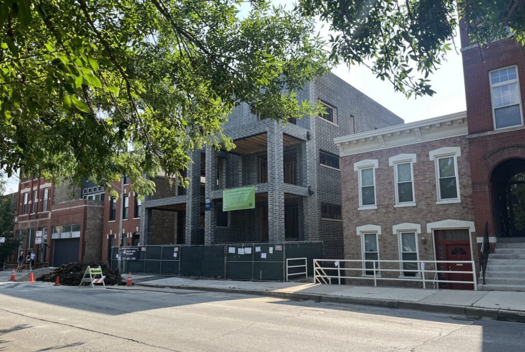 Brick building under construction on city street