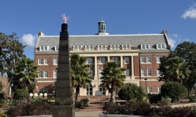 Brick academic building with flaming obelisk monument