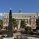 Brick academic building with flaming obelisk monument