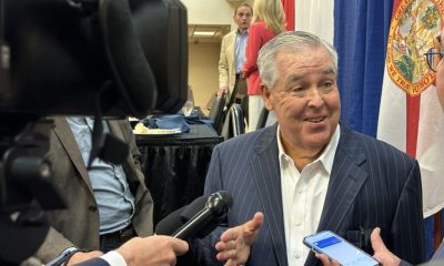 Man speaking to reporters at press event