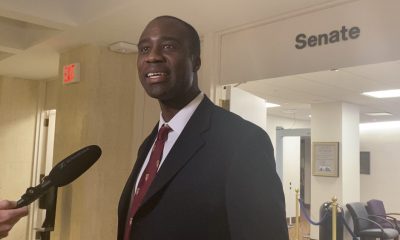 Man speaking near Senate office hallway microphone