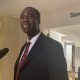 Man speaking near Senate office hallway microphone