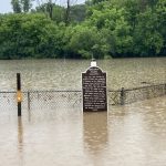 Flooded Milwaukee County Cemetery sign and fence — Northwest Florida FEMA disaster aid