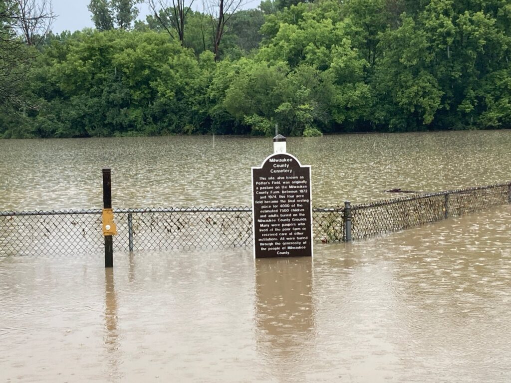 Flooded Milwaukee County Cemetery sign and fence