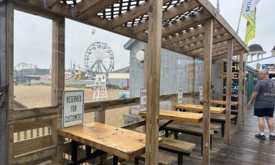 Covered boardwalk seating near beach amusement park