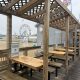 Covered boardwalk seating near beach amusement park
