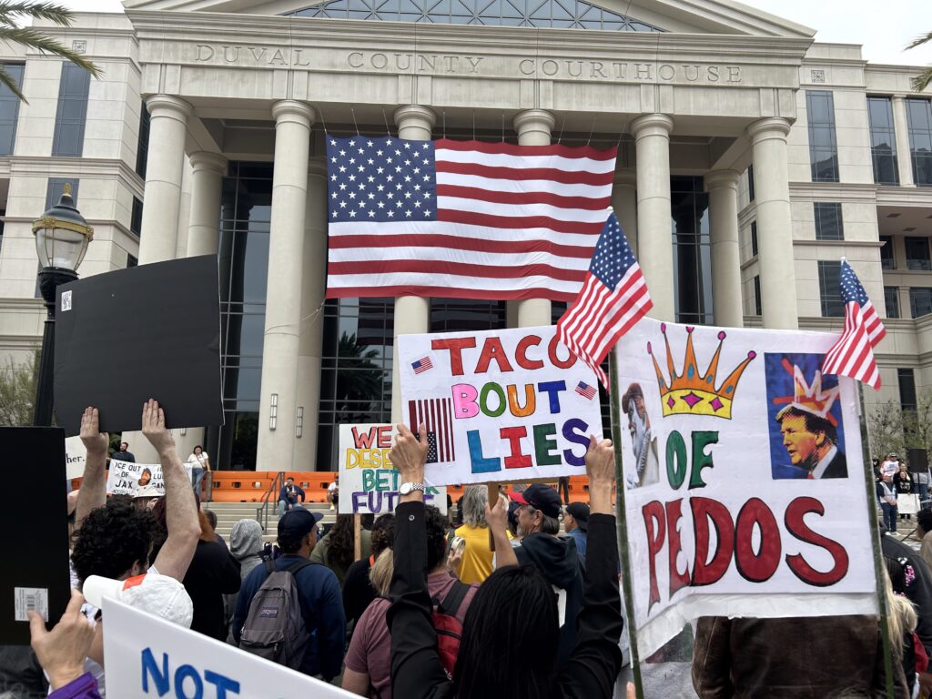 Protesters with signs outside Duval County Courthouse