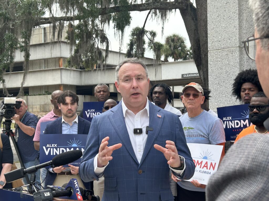 Man speaking at outdoor campaign press conference