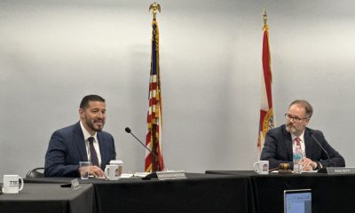 Two men speaking at formal meeting table