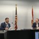Two men speaking at formal meeting table