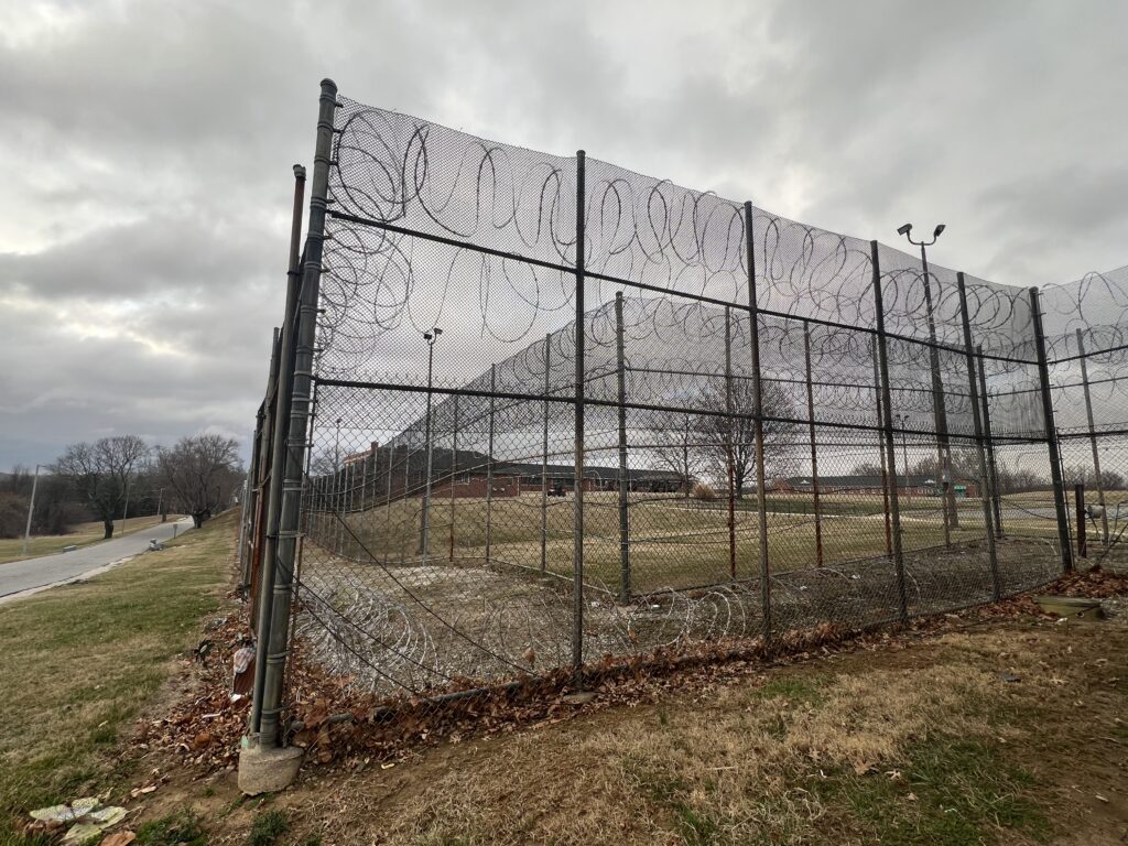 Barbed wire fence surrounding prison yard