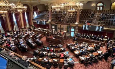 Ornate legislative chamber during session with lawmakers seated
