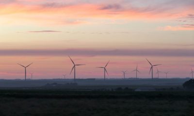 Wind turbines at sunset over rural landscape