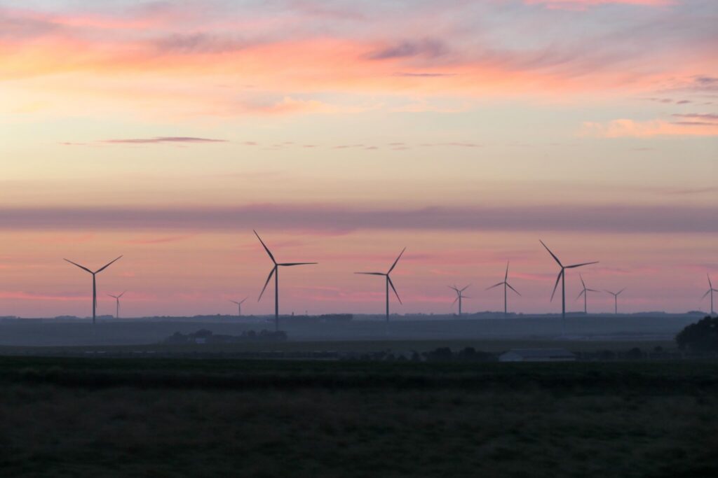 Wind turbines at sunset over rural landscape